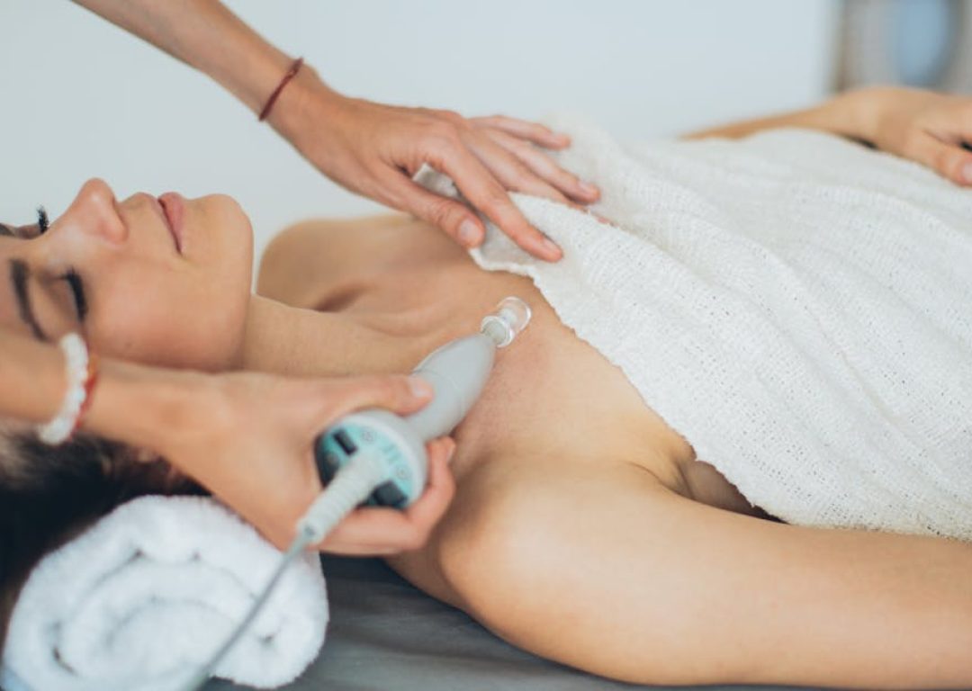 Woman receiving a laser spa treatment focused on relaxation and wellness.