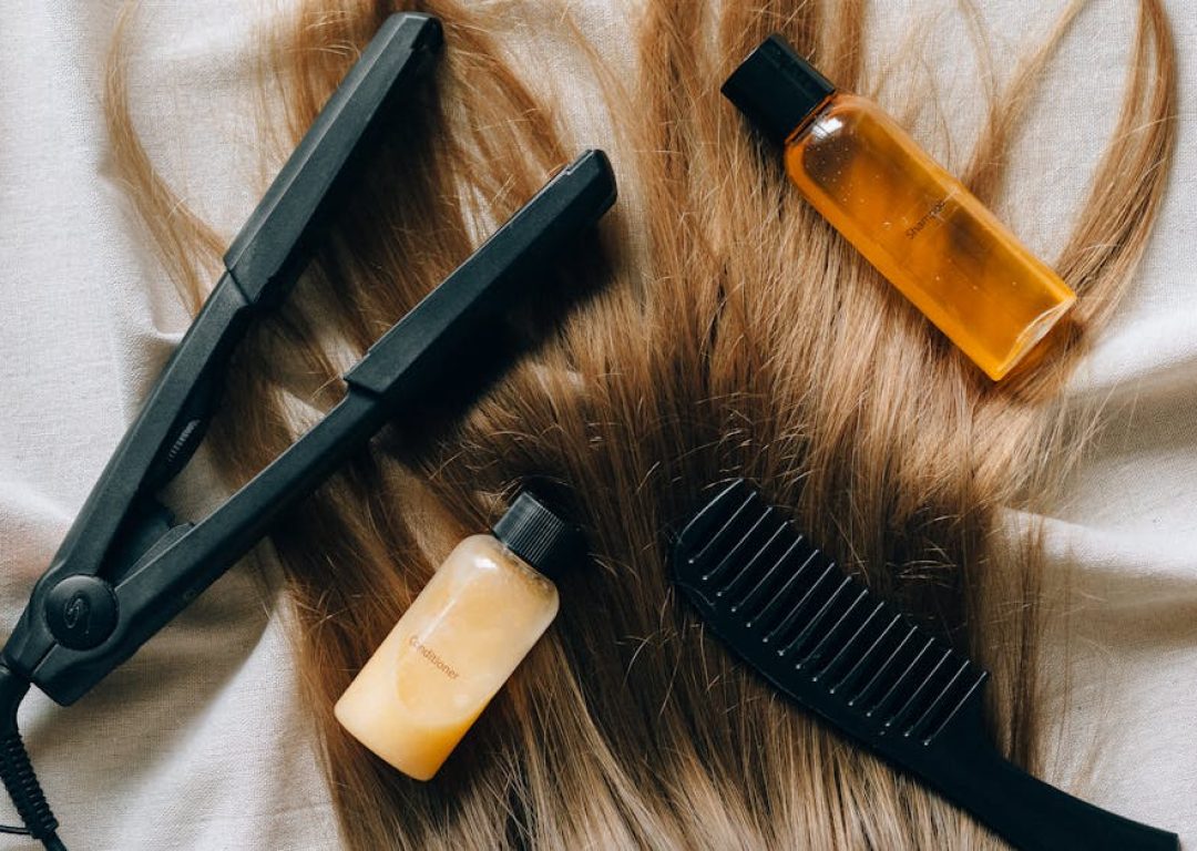 Aesthetic flat lay of hair products and tools for styling and grooming.